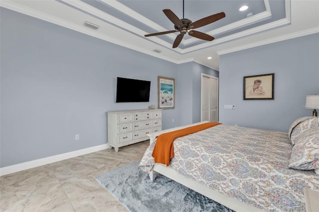 bedroom with crown molding, ceiling fan, a raised ceiling, and a closet