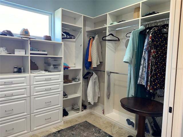 walk in closet featuring light tile patterned flooring