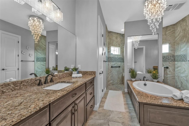 bathroom with an inviting chandelier, vanity, and separate shower and tub