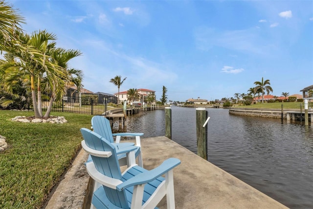 view of dock featuring a water view and a lawn