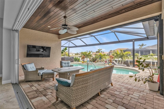 view of patio / terrace with ceiling fan and glass enclosure