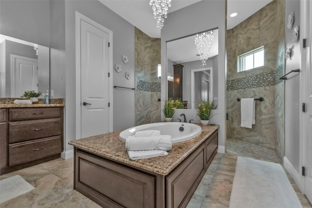 bathroom featuring vanity, a notable chandelier, and plus walk in shower