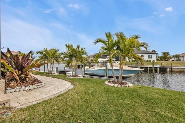 view of yard with a boat dock and a water view