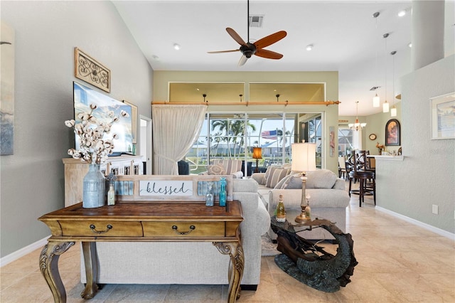 living room featuring ceiling fan with notable chandelier