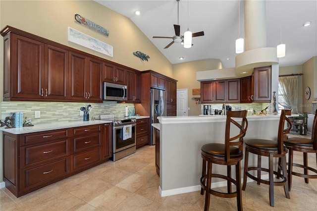 kitchen featuring backsplash, high vaulted ceiling, stainless steel appliances, and decorative light fixtures