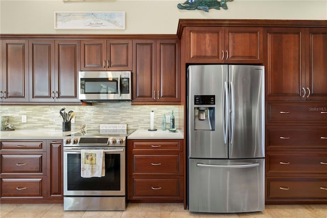 kitchen featuring light tile patterned floors, stainless steel appliances, and tasteful backsplash