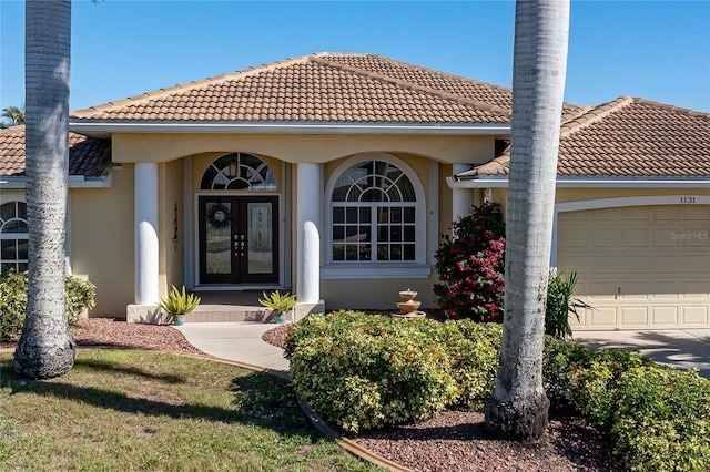 entrance to property featuring french doors and a garage