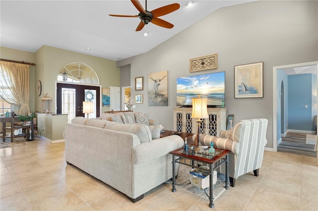 living room with light tile patterned floors, high vaulted ceiling, and ceiling fan