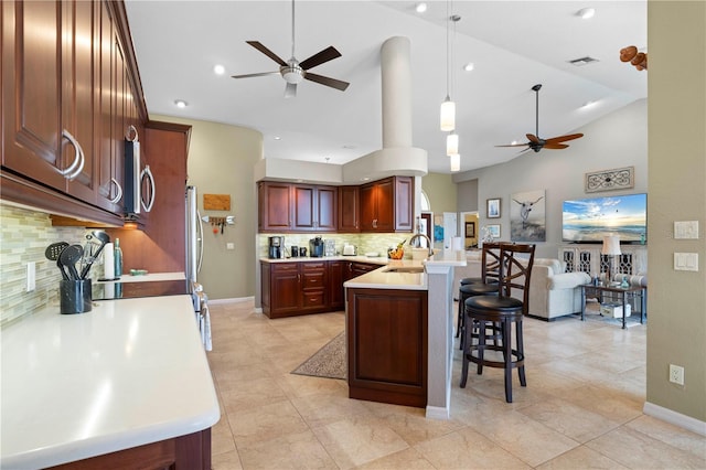 kitchen featuring decorative backsplash, ceiling fan, lofted ceiling, and decorative light fixtures