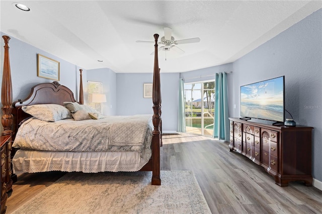 bedroom with access to outside, ceiling fan, and hardwood / wood-style floors