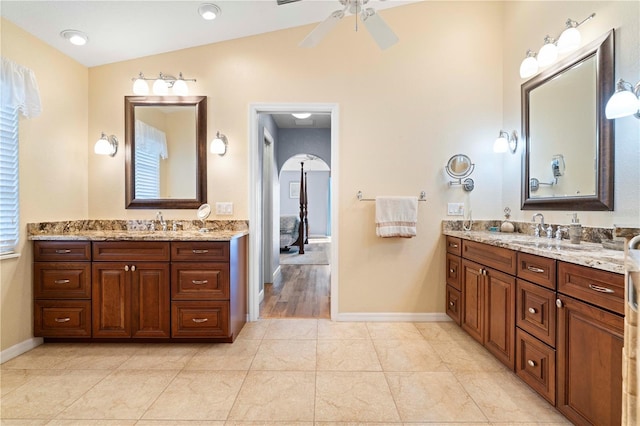 bathroom featuring tile patterned floors, ceiling fan, vanity, and vaulted ceiling