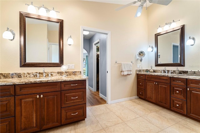 bathroom with tile patterned floors, vanity, and ceiling fan