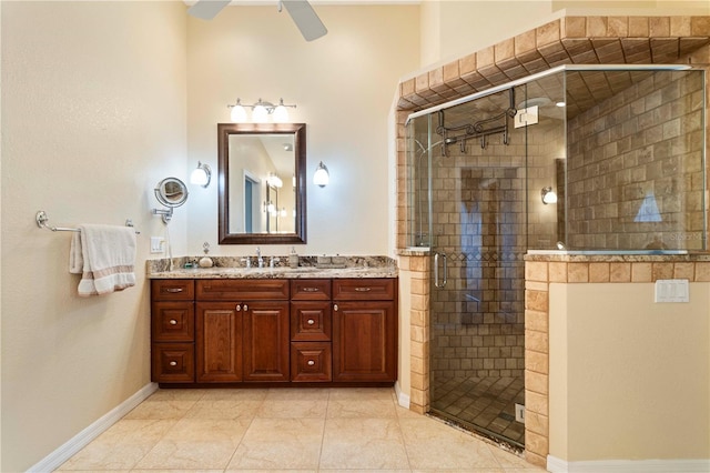 bathroom with tile patterned floors, vanity, ceiling fan, and walk in shower