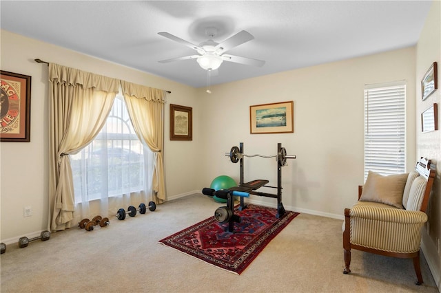 workout room featuring ceiling fan and light colored carpet