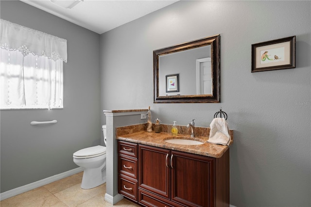 bathroom with tile patterned floors, vanity, and toilet