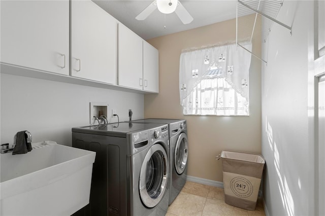 washroom featuring ceiling fan, sink, cabinets, washing machine and dryer, and light tile patterned floors