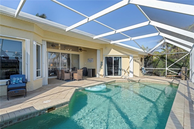 view of swimming pool featuring a patio and a lanai