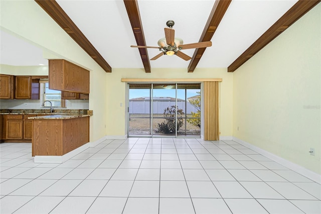 kitchen with light tile patterned flooring, ceiling fan, a wealth of natural light, and a mountain view