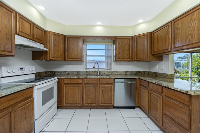 kitchen with sink, white range with electric stovetop, dishwasher, and dark stone countertops