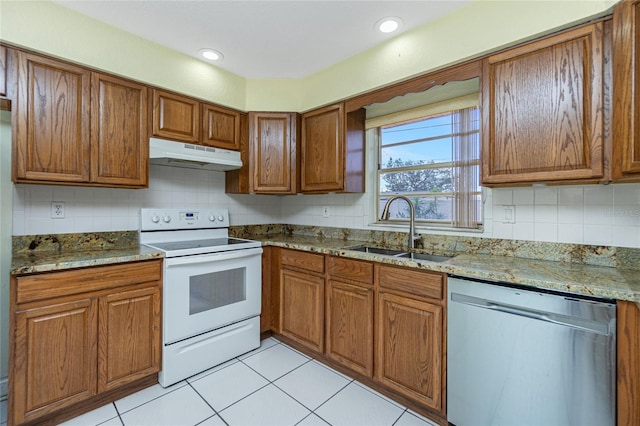 kitchen featuring white electric range oven, light tile patterned flooring, dishwasher, light stone countertops, and sink