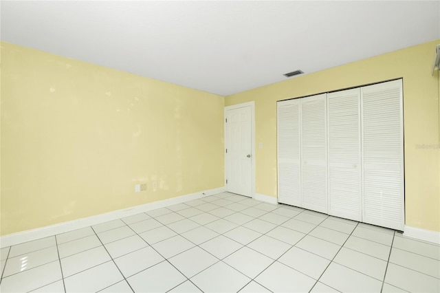 unfurnished bedroom with a closet and light tile patterned floors