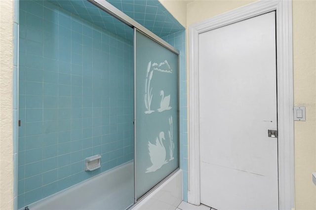 bathroom featuring shower / bath combination with glass door and tile patterned flooring