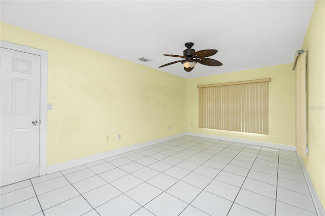 tiled spare room featuring ceiling fan