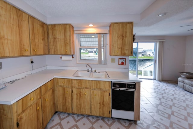 kitchen with a textured ceiling and sink