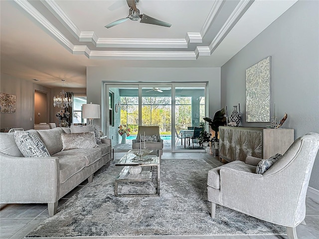 tiled living room featuring ceiling fan with notable chandelier, a raised ceiling, and crown molding