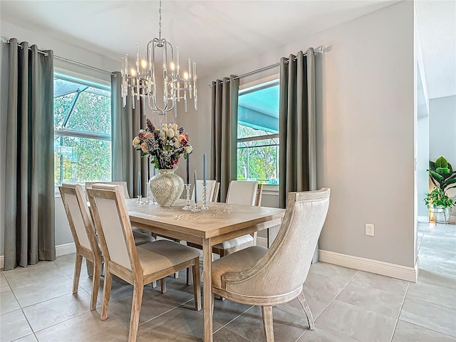 dining space featuring light tile patterned floors and an inviting chandelier