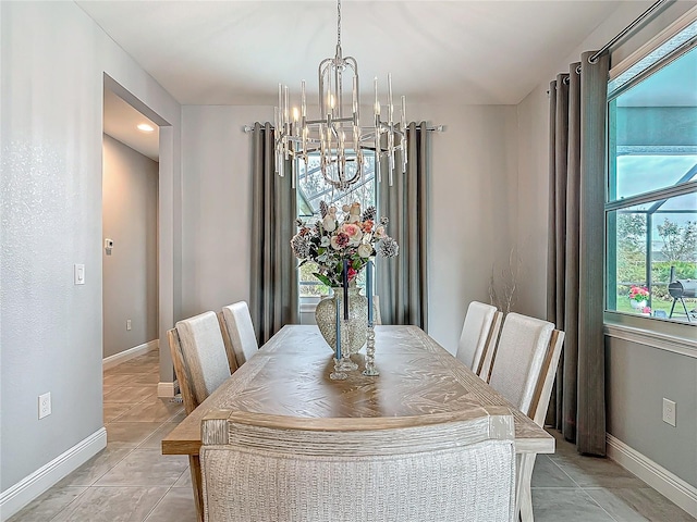 tiled dining area featuring an inviting chandelier