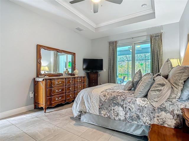 tiled bedroom featuring a tray ceiling, ceiling fan, and crown molding