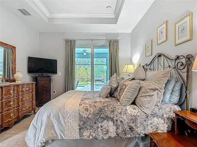 tiled bedroom featuring a tray ceiling, access to exterior, and ornamental molding