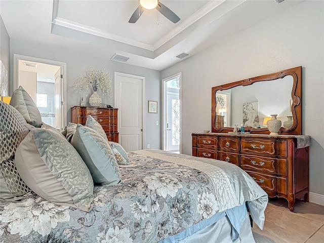 bedroom featuring ensuite bath, ornamental molding, a raised ceiling, ceiling fan, and light tile patterned floors