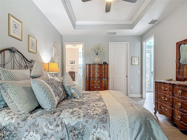 tiled bedroom featuring a tray ceiling, ceiling fan, and crown molding