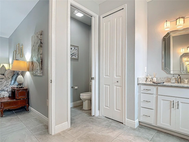 bathroom featuring tile patterned floors, vanity, and toilet