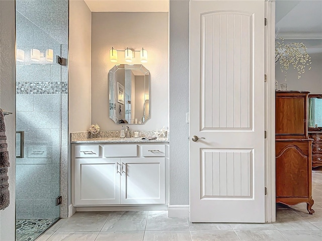 bathroom with tile patterned flooring, vanity, and a shower with shower door