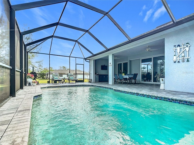 view of swimming pool featuring a lanai, ceiling fan, and a patio area