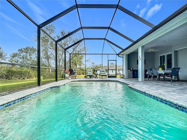 view of pool with a lanai, ceiling fan, and a patio area