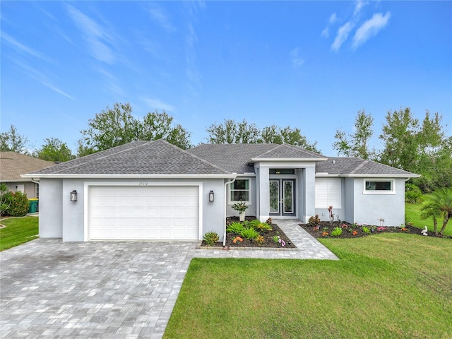 view of front facade with a garage and a front lawn