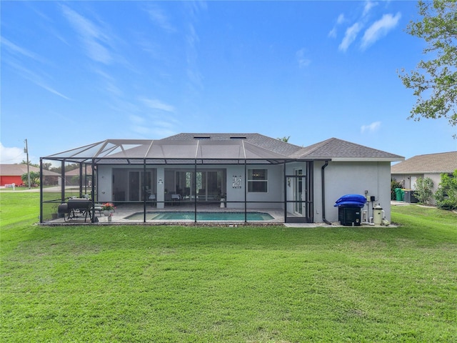 back of property with a patio, a lanai, and a lawn