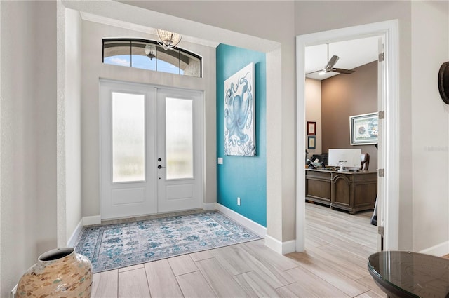 entrance foyer featuring french doors, ceiling fan, and a healthy amount of sunlight