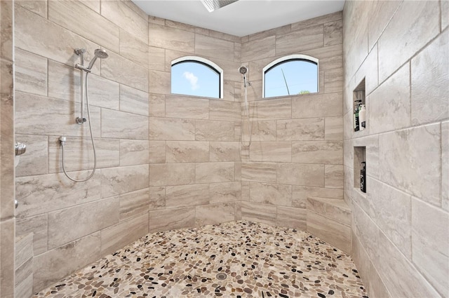 bathroom featuring a tile shower