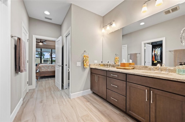 bathroom featuring wood-type flooring, vanity, and ceiling fan