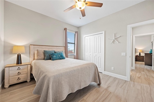 bedroom with ceiling fan, light hardwood / wood-style flooring, and a closet