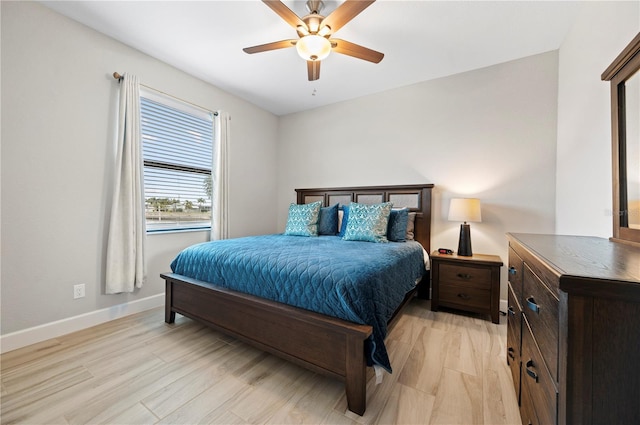 bedroom with ceiling fan and light wood-type flooring