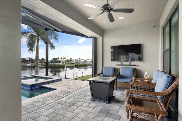 view of patio with an in ground hot tub, ceiling fan, and an outdoor hangout area