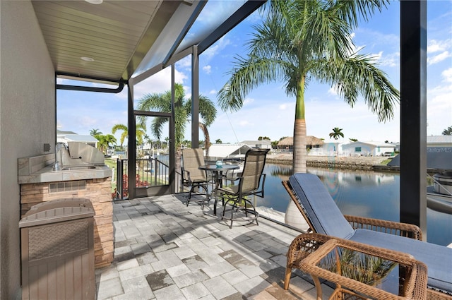 view of patio / terrace with an outdoor kitchen and a water view