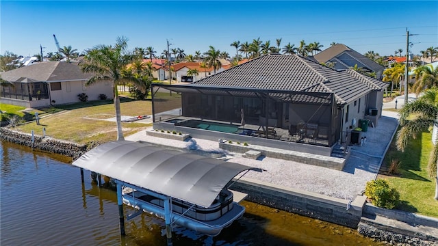 dock area featuring a lanai, a yard, a water view, and a patio