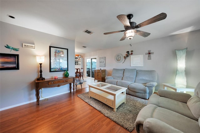 living room featuring hardwood / wood-style floors and ceiling fan